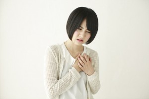 両手で胸を押さえる日本人女性